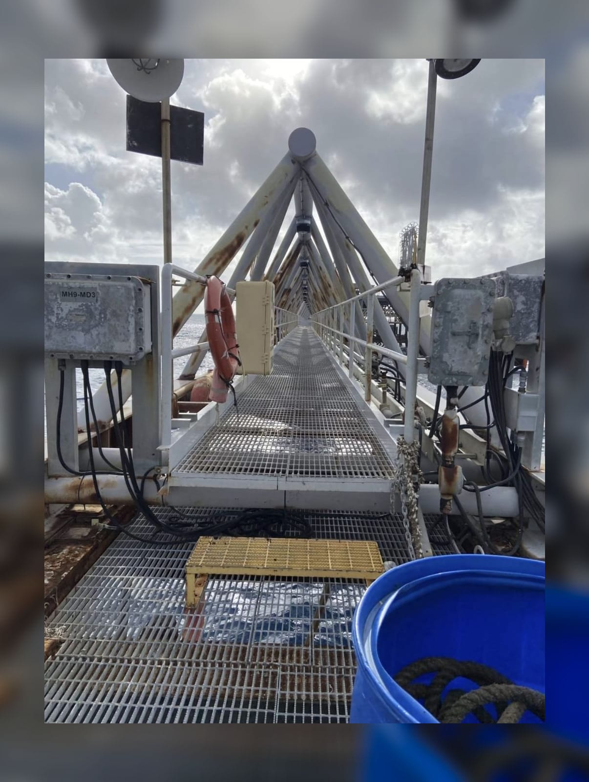 Offshore steel truss gangway walkway extending over open water